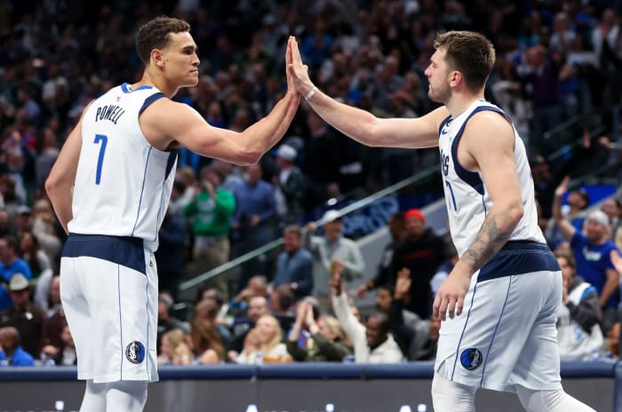 Dallas Mavs' Dwight Powell and Luka Doncic share a high five against the Los Angeles Clippers.